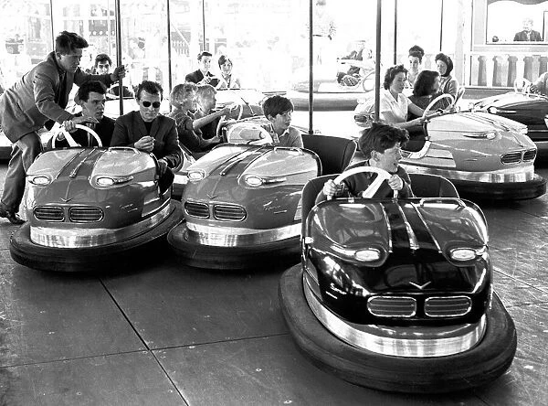 People enjoying the dodgems ride at Hearsall Common fair, Coventry. 3rd June 1963