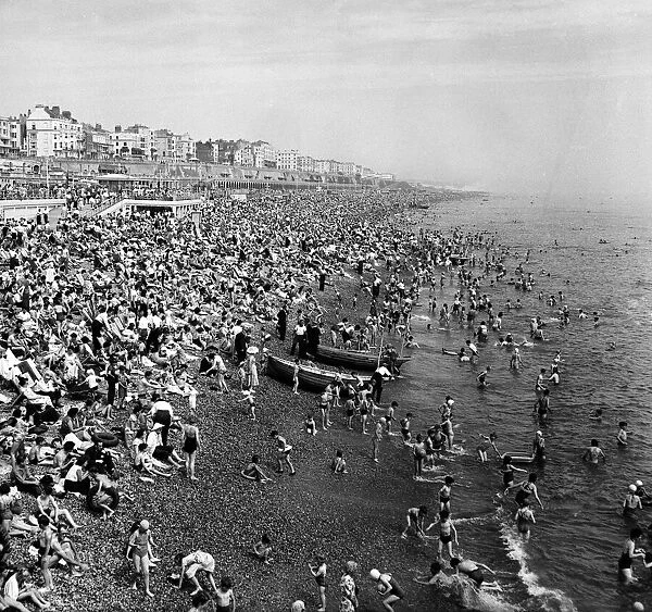 People enjoying the hot weather in Brighton, East Sussex. July 1957