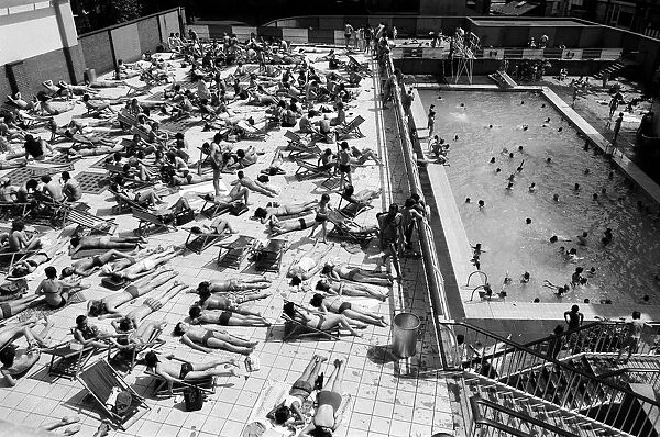 People enjoying the hot weather at the Oasis outdoor swimming pool Lido, London