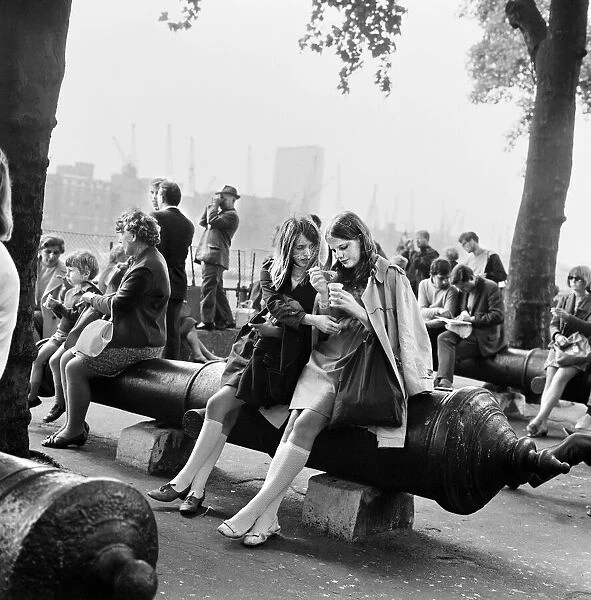 People enjoying life on the embankment in London. 2nd August 1968