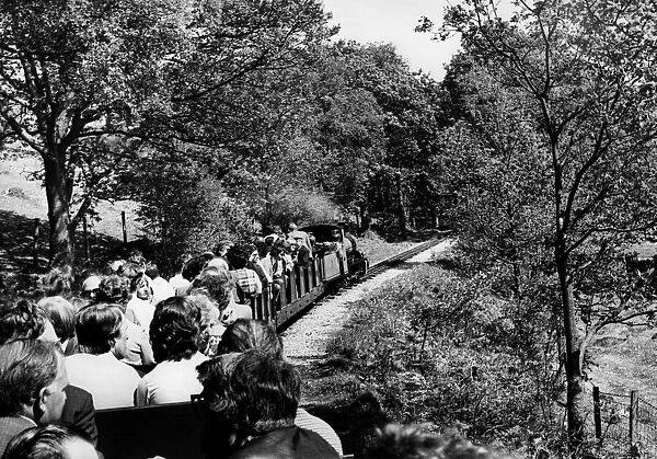 People enjoying a ride on a miniature railway on 20th May 1977