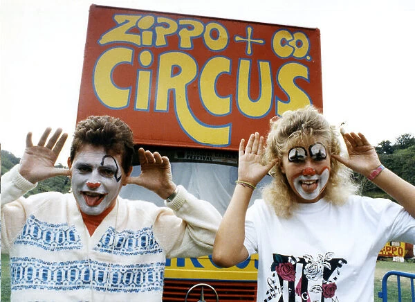 Two people with their faces painted like clowns, pulling funny faces, at the Zippo & Co