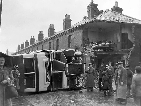 People gather round an overturned bus Bus in Sparbrook, Birmingham following an air raid