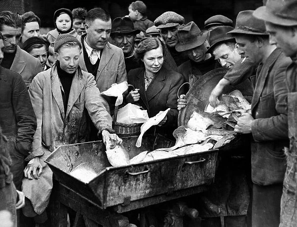 People help themselves to fish at the market, March 1946. Location Unknown