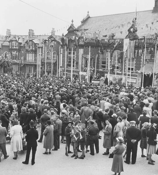 The people of Paignton gather outside the Palace Avenue Theatre in May 1945 to celebrate