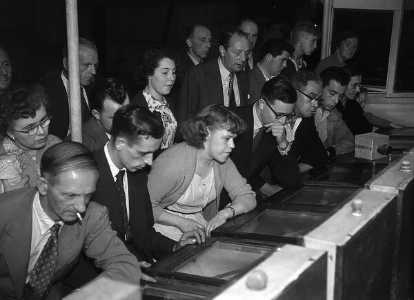 People playing the Twenty One Game in a Sixpenny Casino stall in Blackpool