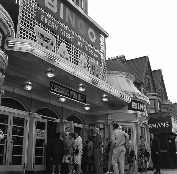 People queue outside the Gaiety Theatre, to play bingo. 31st July 1963
