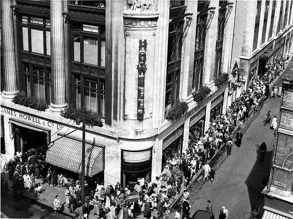 People queue outside Howells department store, St Mary Street, Cardiff. 7th August 1958