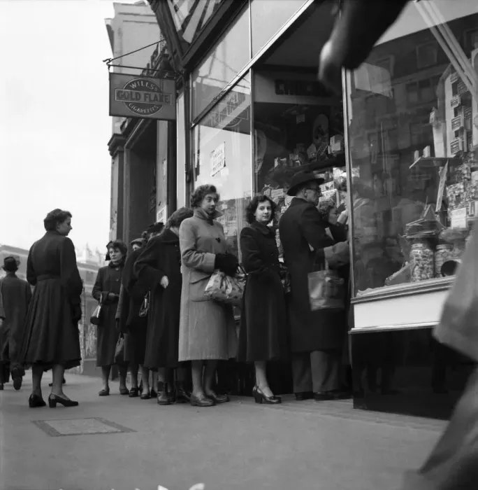 Framed Print : People queuing up outside a confectioney shop after sweets came off the ration following