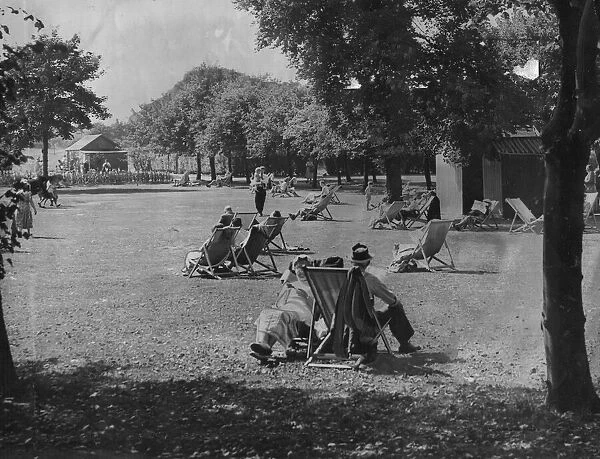 People relaxing in the summer sunshine at Exhibition Park in Newcastle