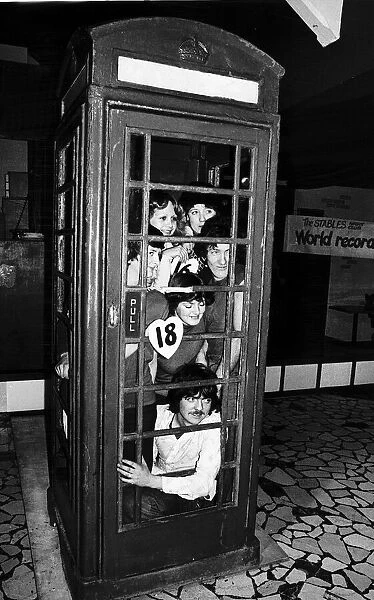 Twenty people set a record for squeezing into a telephone box. January 1978