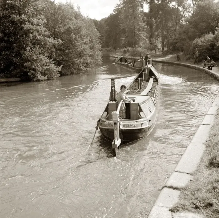 Framed Print : People steering their narrow boats along the canal, with People fishing along
