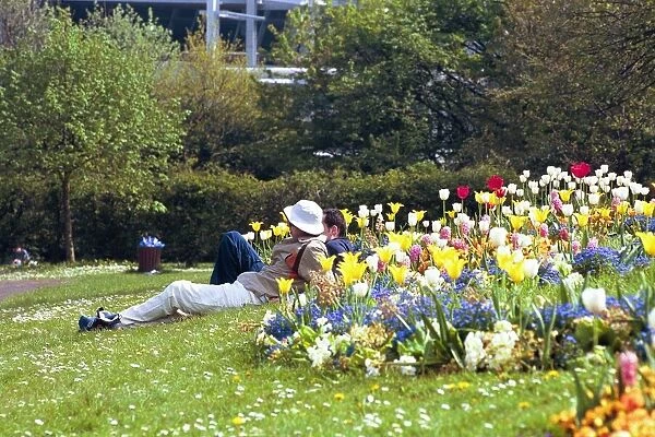 People sun bathing and relaxing in the Bank Holiday weather in Leazes Park