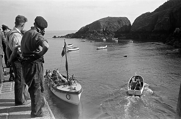 People watch the boats off the coast of Sark, Channel Islands. July 1947