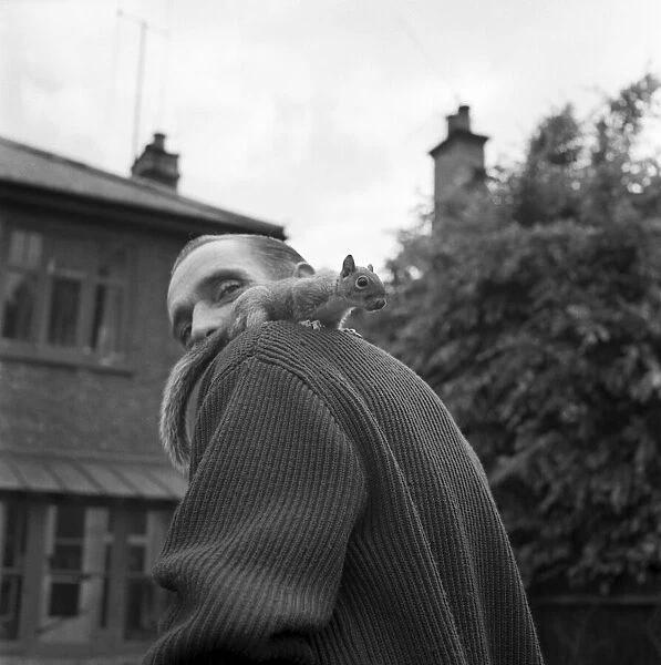 Pet Squirrel John Willy seen here on the shoulder of a man. June 1960 M4257-006