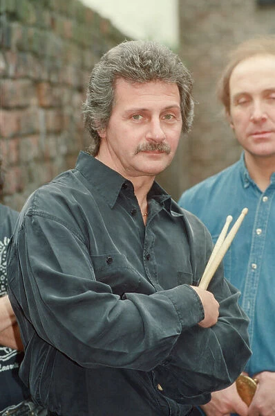 Pete Best, (in the black shirt holding his drum sticks) posing for the camera with his
