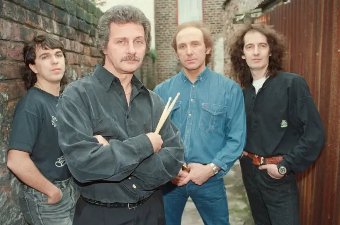 Framed Print : Pete Best, (in the black shirt holding his drum sticks) posing for the camera with his Framed Print : Pete Best, (in the black shirt holding his drum sticks) posing for the camera with his