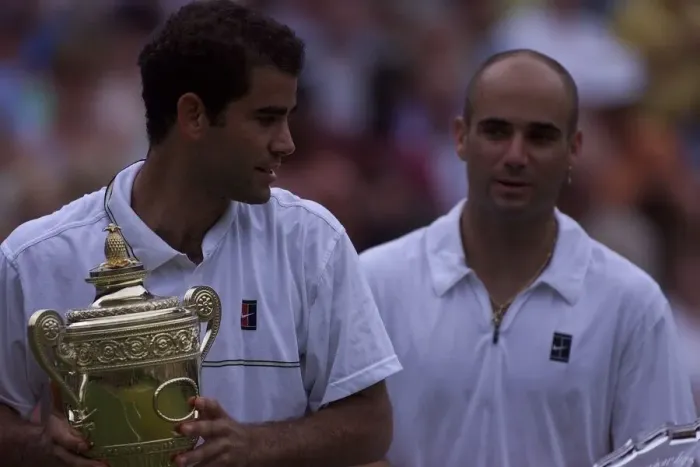 Framed Print : Pete Sampras with trophy watched by Andre Agassi after Pete had won the Mens Final