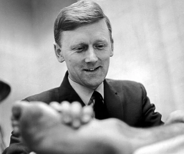 Peter Blakey, Manchester Citys Physiotherapist seen here inspecting players feet