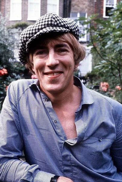 Peter Cook actor at home in his garden wearing a hat