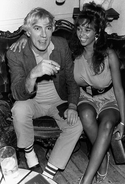 Peter Cook comedian actor and satarist, in July 1987 with topless model Maria Whittaker