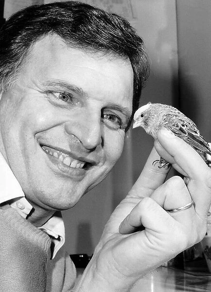 Peter Dean actor in the soap Eastenders with one of his twenty four Canaries