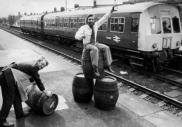 Peter Gill (pushing barrel) and Dave Young (sitting on barrels