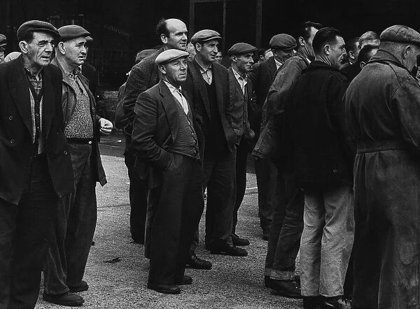 Peter Pearson (centre) a docker waits with other dockers for their allocation of work to