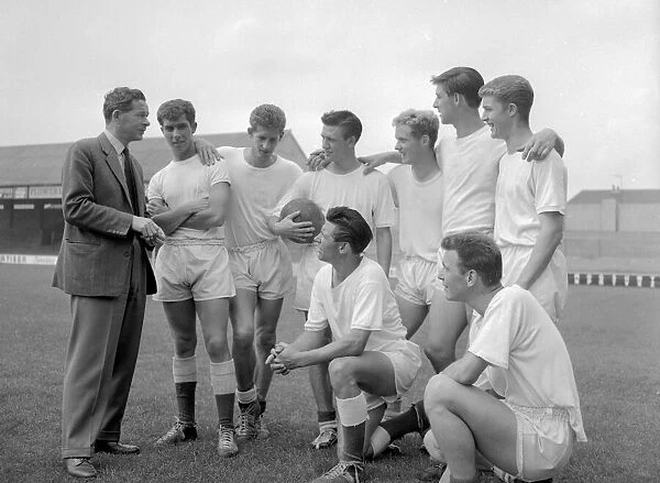 Peterborough team listen to their manager before a training session August 1960