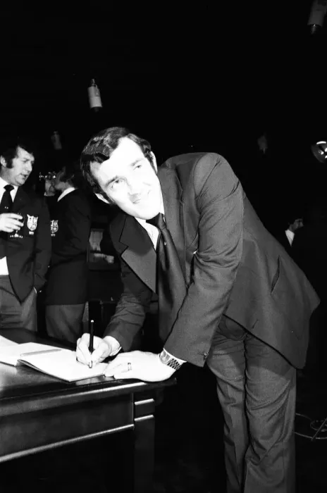 Framed Print : Phil Bennett signing the visitors book at the International Sports Writers Club in Great
