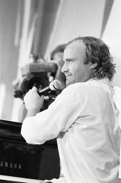 Phil Collins performing on stage at the John F. Kennedy Stadium, Philadelphia