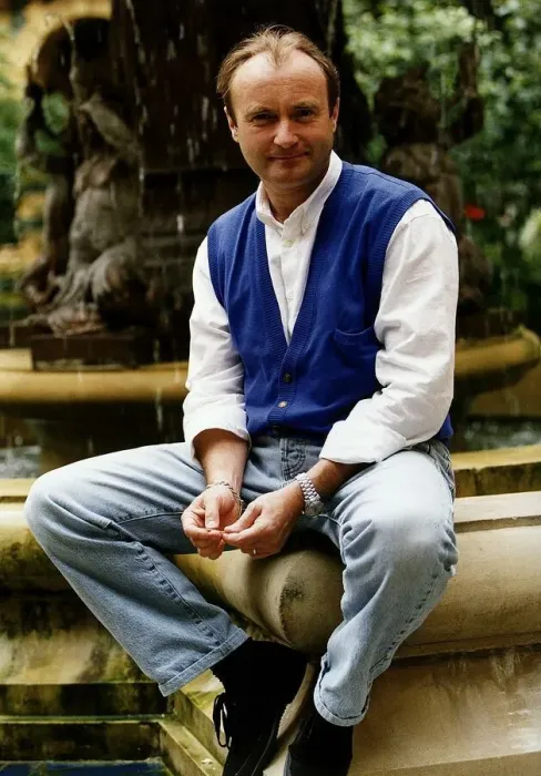 Framed Print : Phil Collins singer poses for a picture while sitting on the edge of a water fountain