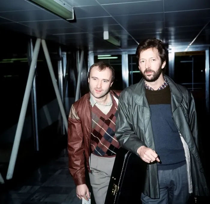 Framed Print : Phil Collins Singer Songwriter Actor with Eric Clapton leaving London Airport for Framed Print : Phil Collins Singer Songwriter Actor with Eric Clapton leaving London Airport for