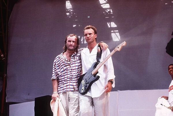 Phil Collins and Sting stand on the stage at Live Aid Charity concert at Wembley Stadium