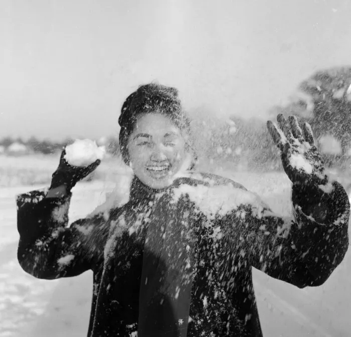 Framed Print : Philippine dancers have a snowball fight in London. One of the woman throwing Framed Print : Philippine dancers have a snowball fight in London. One of the woman throwing