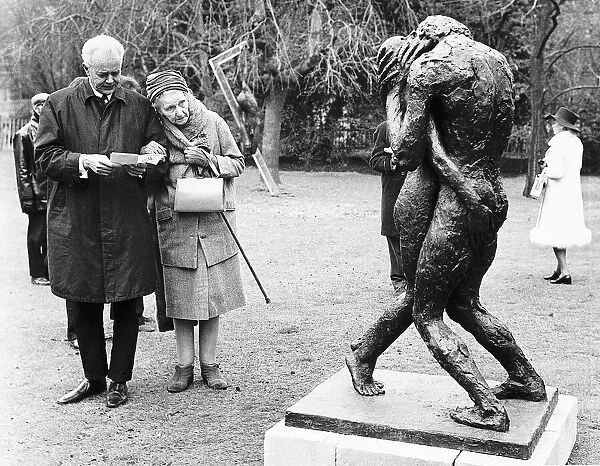 A photograph of an elderly couple viewing the sculpture 'Eternity I I'