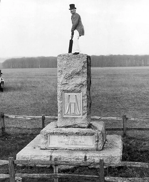 Piccolo Jim stands atop a stone marking the site of the ground of the Hambledon Cricket