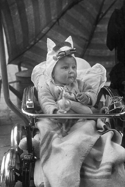 Picture shows a baby in Brussels, Belgium, wearing a bonnet with the British regiment The