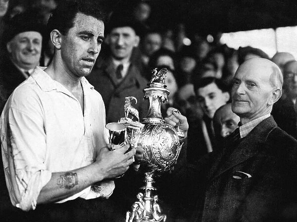 PICTURE SHOWS: Mr E. J. Morgan (vice-president) presenting the Welsh Cup to Roy Paul
