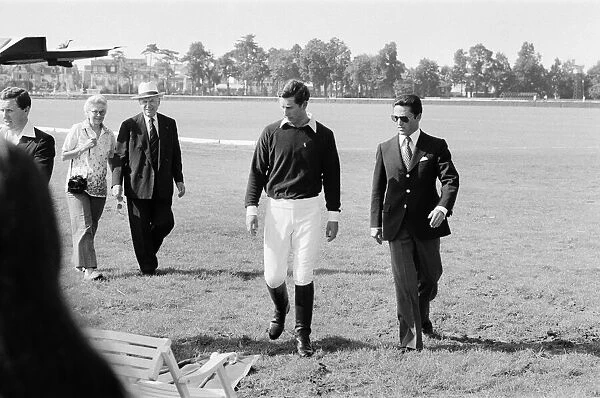 Picture shows Prince Charles (left) leaving the polo field with his friend