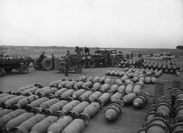 Picture taken at an RAF Bomber Command Station. Loaded bomb trains are leaving the dumps