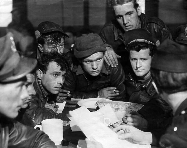 Pilots of the American 8th Air Force being debriefed by an Intelligence Officer following