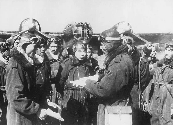 Pilots of the Chinese Air Force receive instructions from officers before taking off for