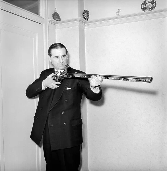 Pip Roberts a collector of antique firearms, seen here demonstrating a flintlock rifle