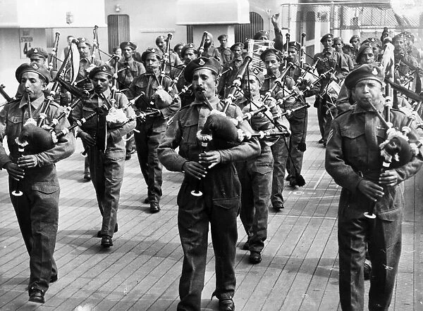 The pipe band of the 8th punjab regiments on the deck of the RMS Mauritania