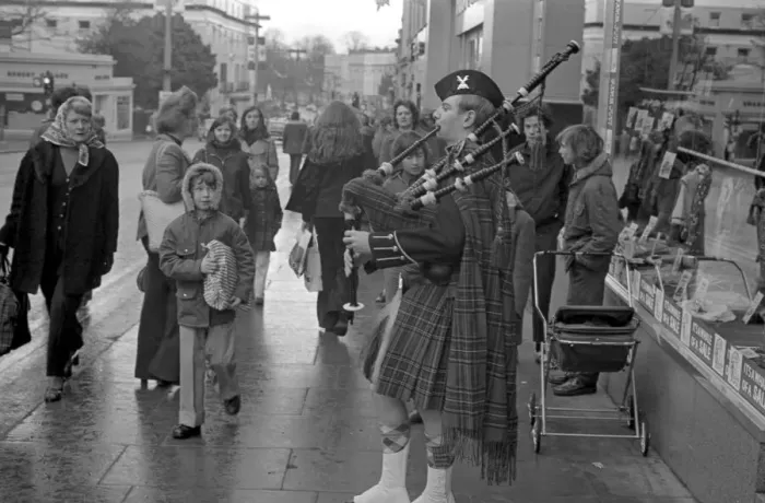 Framed Print : A piper plays the bagpipes dressed in full Scottish national costume including a kilt in