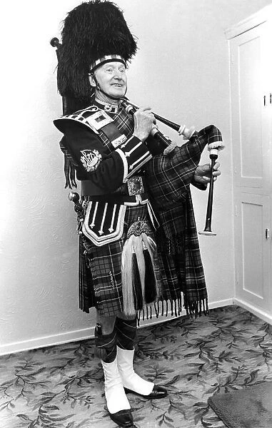 A piper smarly dressed in his uniforn and ready to play the bagpipes in March 1982