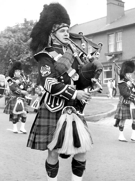 Pipers marching along and playing in July 1971. 12  /  07  /  71