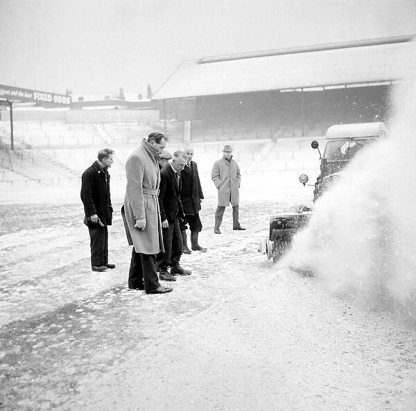 Pitch Inspection. Birmingham grounds staff seen here clearing snow from the pitch