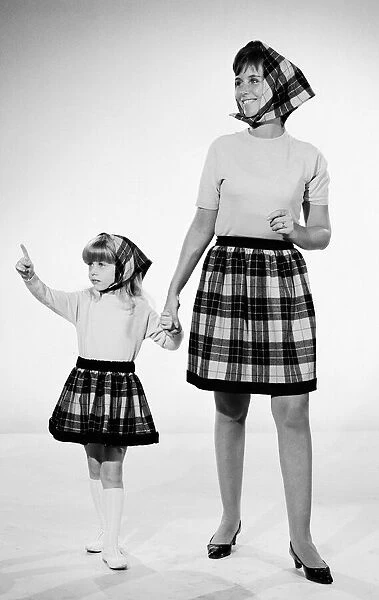 Plaid skirt fashion shoo. Mother and daughter in matching check skirts